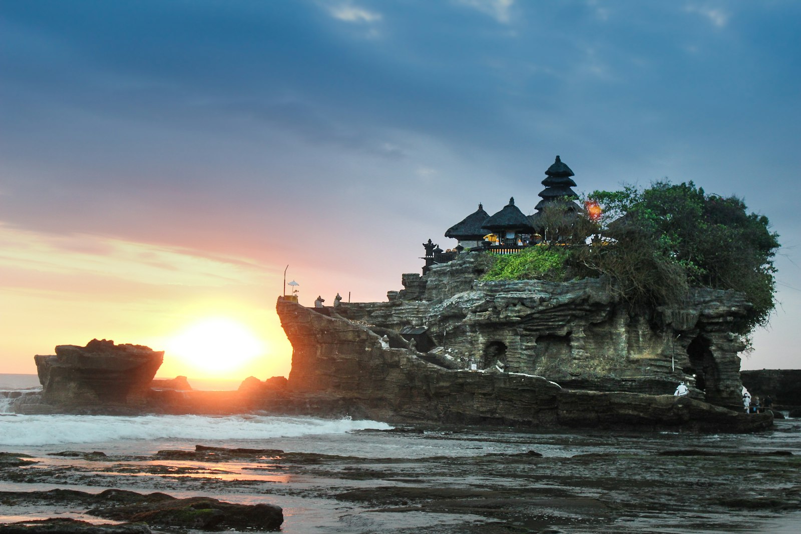 Tanah Lot temple silhouetted against a Bali sunset