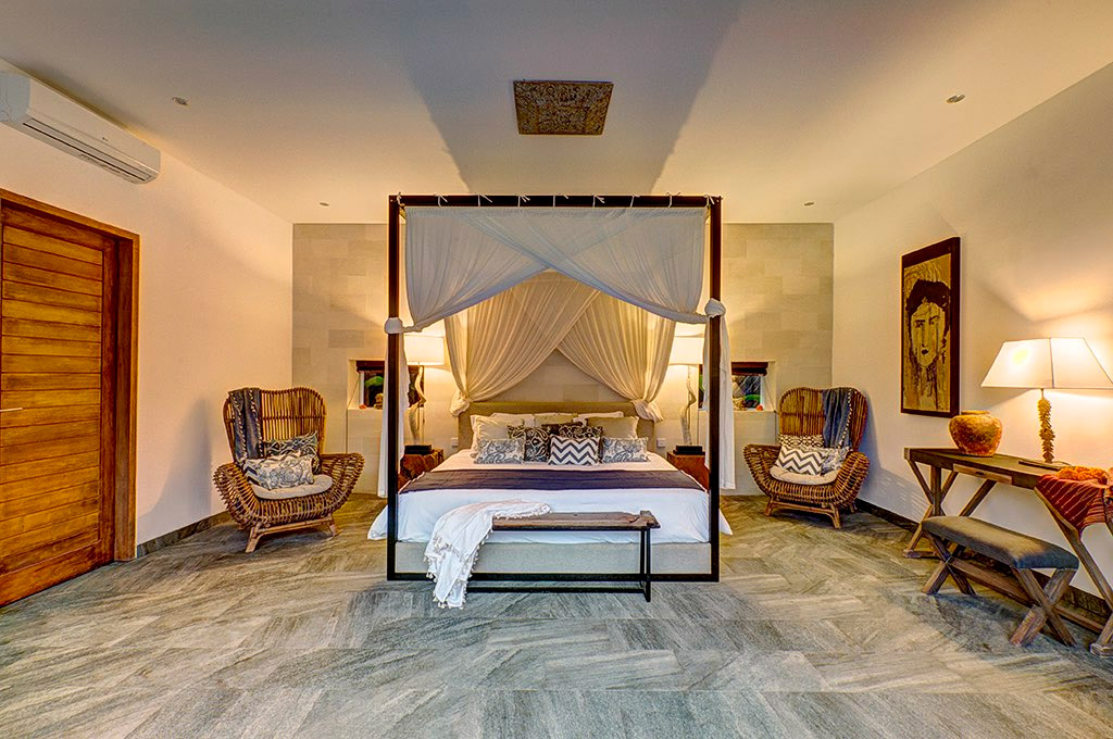 Open upstairs lounge with daybeds and rice-field views at Abaca Villas, Seminyak