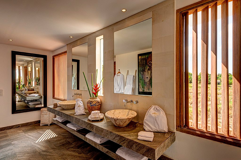 Stone-basin bathroom with a window onto the rice fields at Abaca Villas, Petitenget, Seminyak