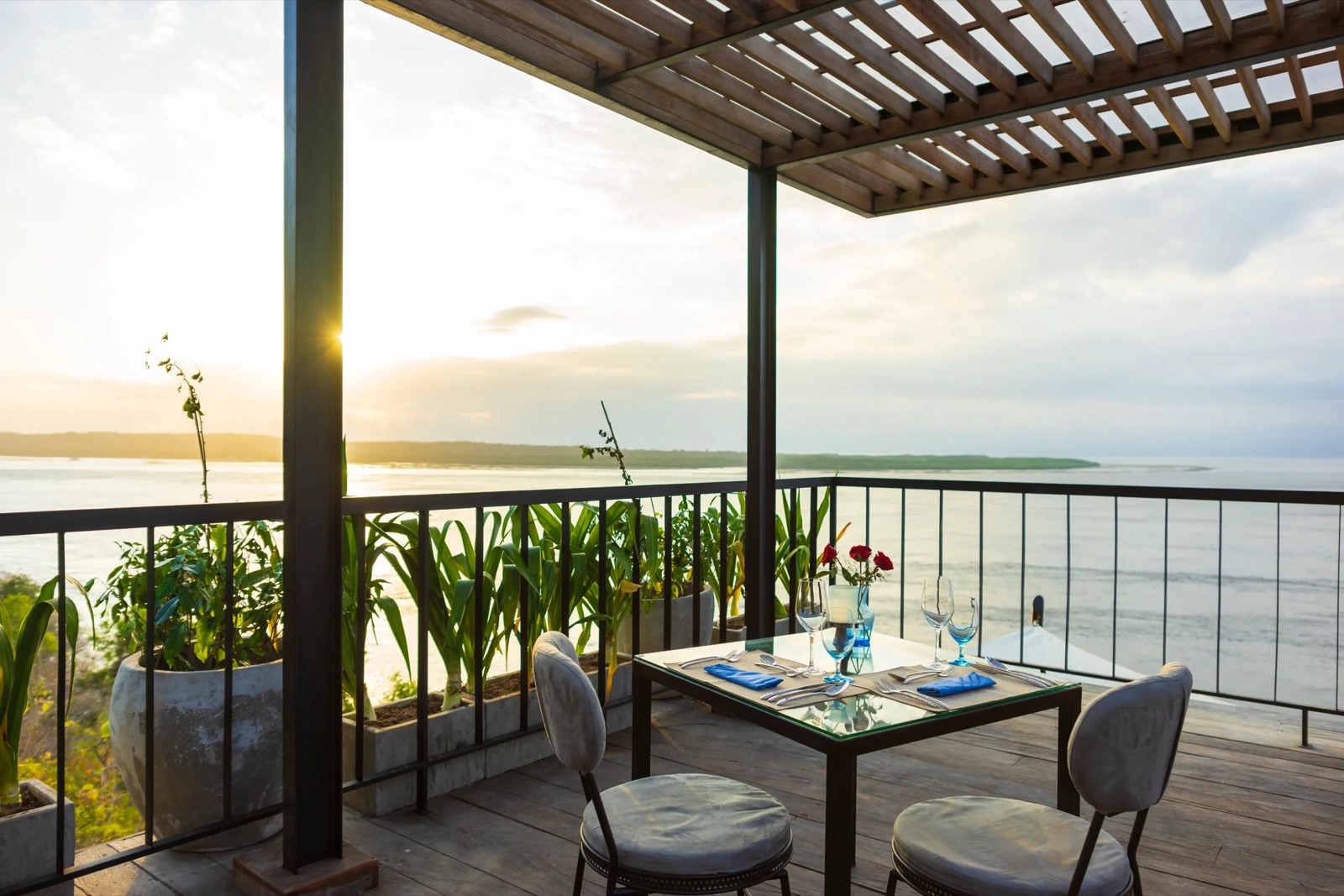 Sunset dinner table on the pergola deck above the strait at Adiwana Warnakali, Nusa Penida, Bali