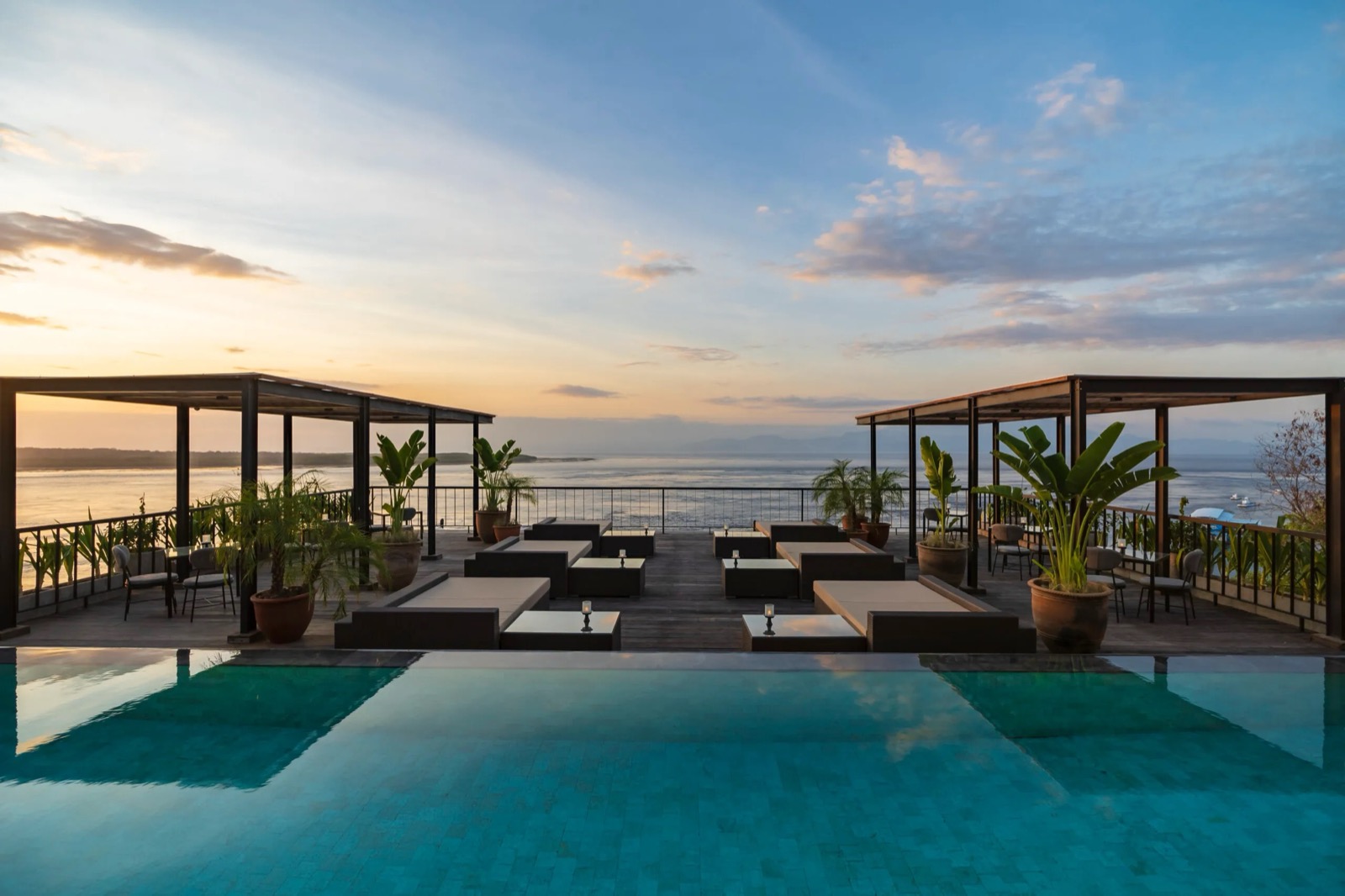 Rooftop infinity pool and pavilions at sunset at Adiwana Warnakali, Nusa Penida, Bali