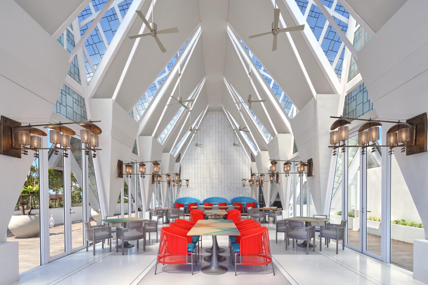 Glass-roofed KAHUNA rooftop pavilion with colourful seating at Aloft Bali Seminyak