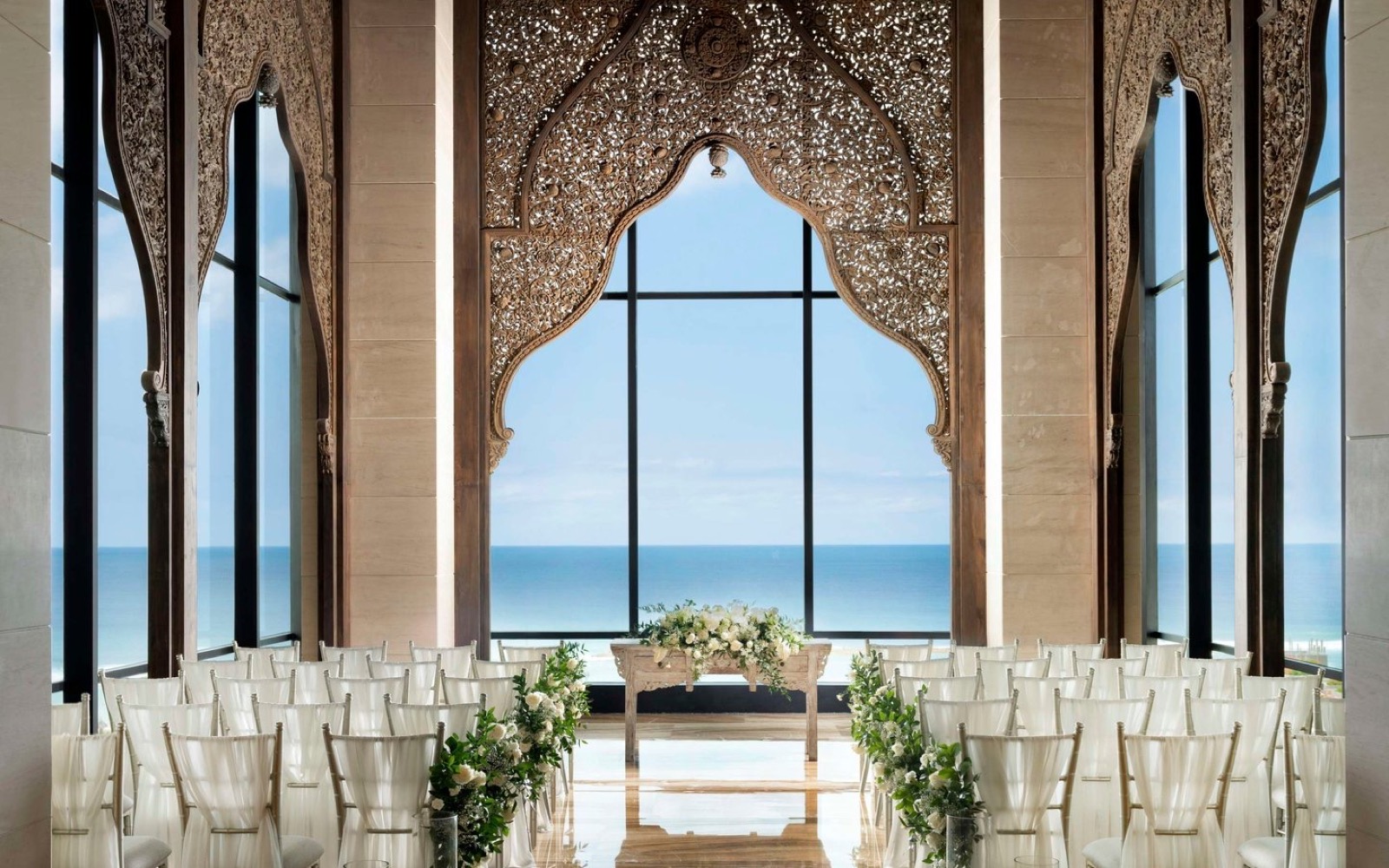 An ocean-view glass cliff chapel at The Apurva Kempinski Bali in Nusa Dua, overlooking the Indian Ocean