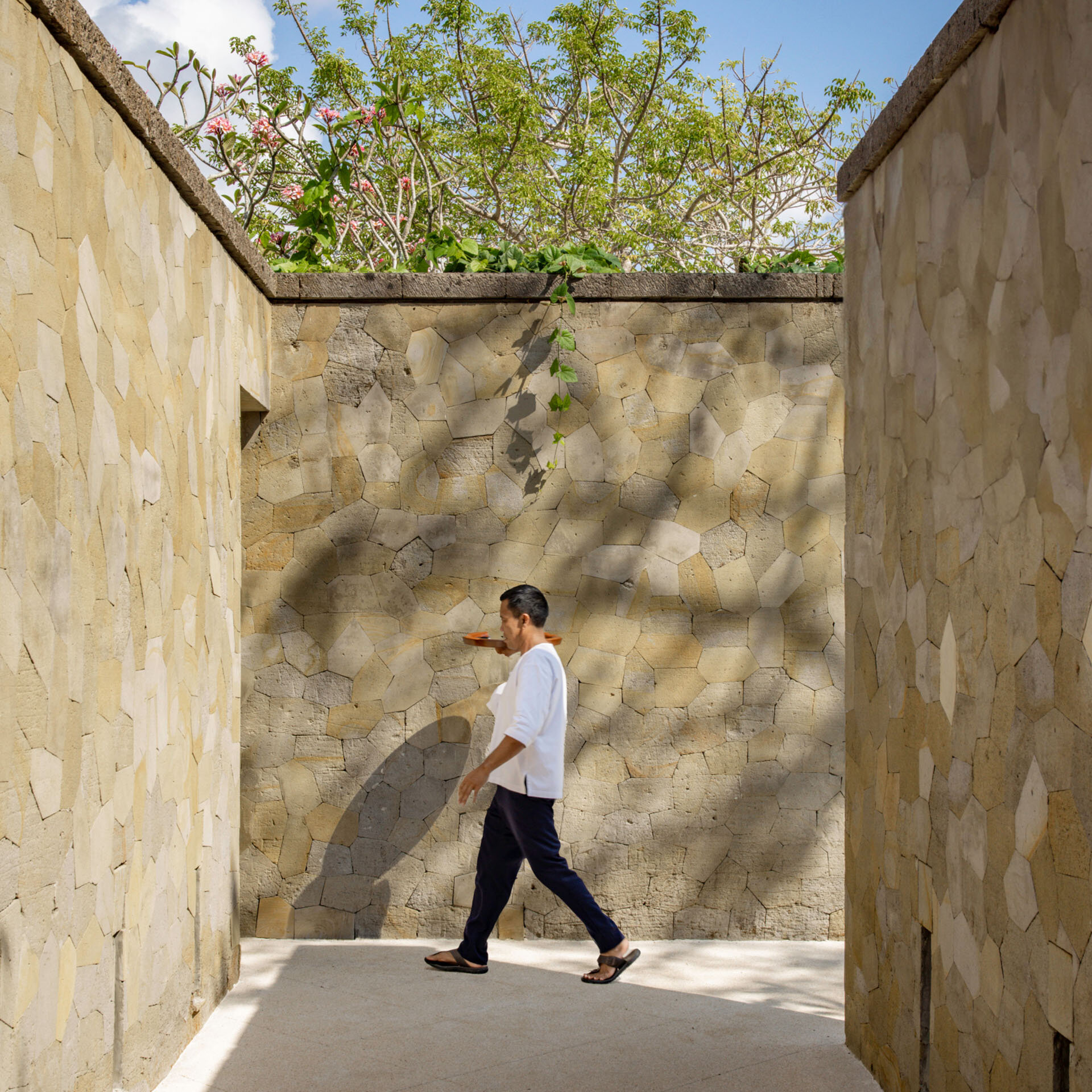 Stone pathway and courtyard with tropical foliage at Aman Villas at Nusa Dua, Nusa Dua