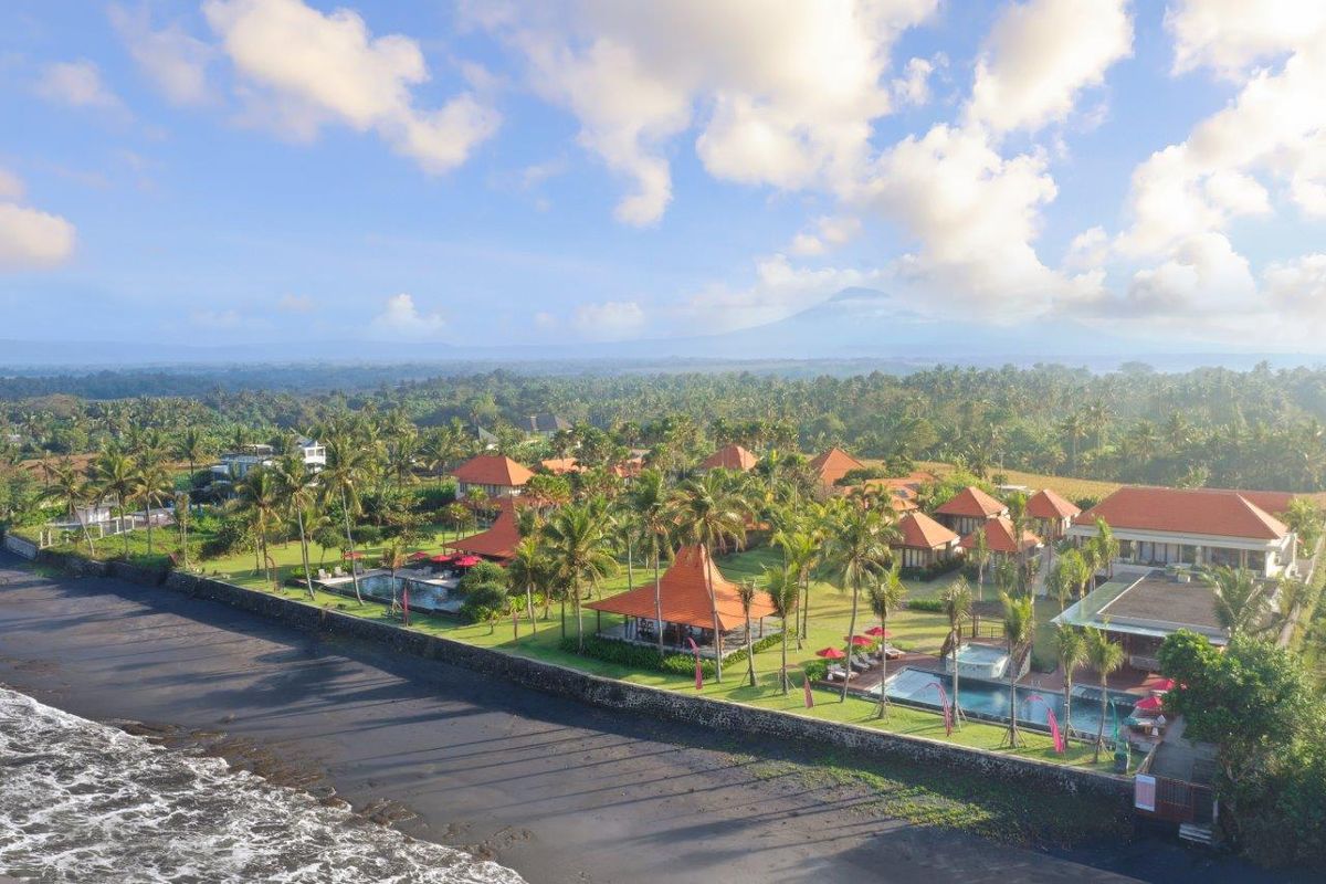 Amarta Beach Retreat seen from the air, black-sand beach and gardens at Pasut, Kerambitan, on Bali's southwest coast