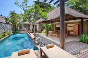 Balinese-style villa bedroom and garden at Amarterra Villas Nusa Dua