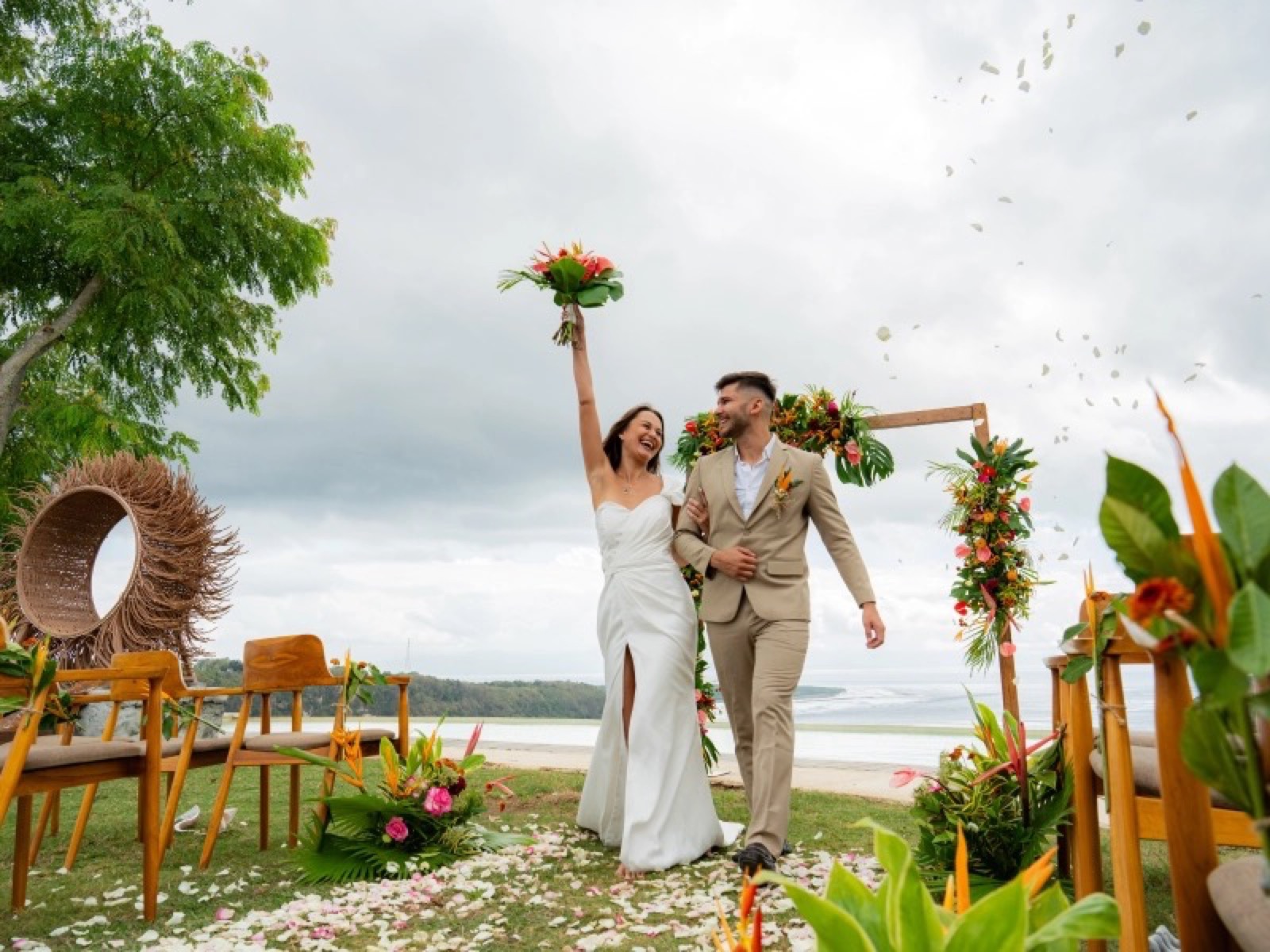 Couple walking up a petal aisle after their ceremony at Amok Sunset on Nusa Penida, Bali