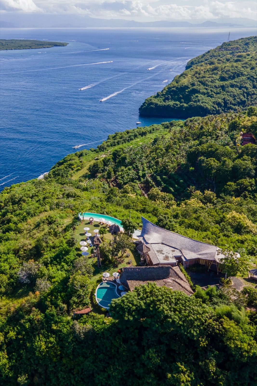Aerial view of Amok Sunset on its clifftop above the Toyapakeh strait, Nusa Penida, Bali
