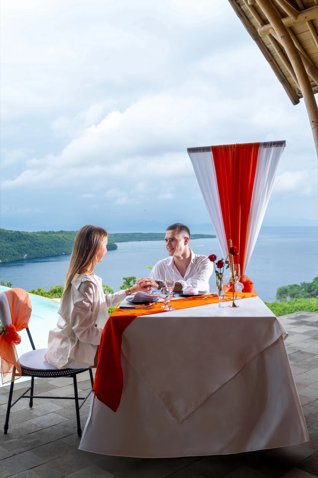 Romantic dinner for two under the bamboo roof overlooking the bay at Amok Sunset, Nusa Penida, Bali