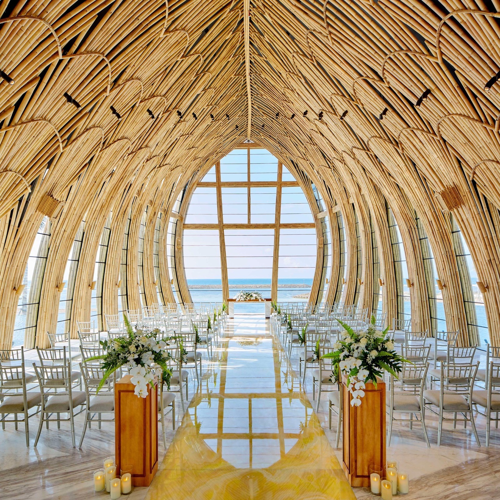 Interior of the Apurva Chapel set with white orchids and the Indian Ocean beyond the glass, Nusa Dua