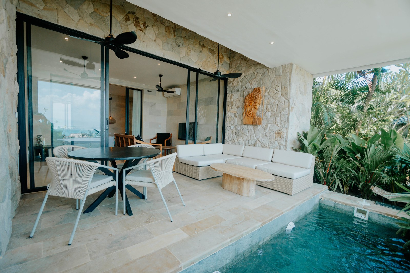 Open-sided living area beside the private pool at an Aqua Nusa villa on Nusa Lembongan, Bali