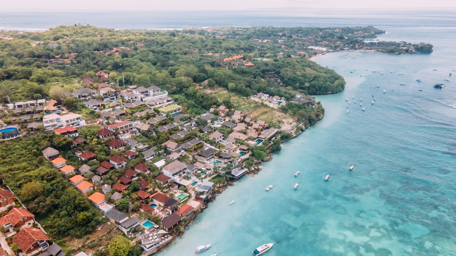 Aerial view over Jungut Batu village and the reef on Nusa Lembongan, Bali, where Aqua Nusa Villas sit on the hill