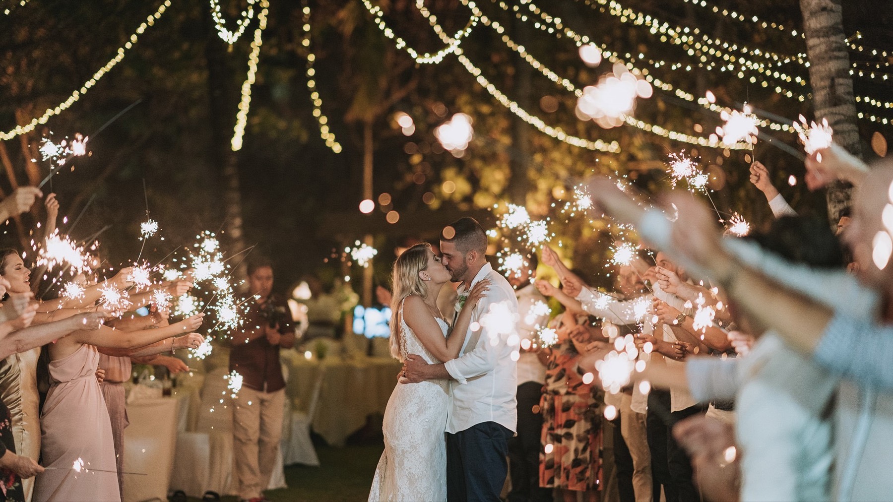 Sparkler send-off for a couple at a fairy-lit garden reception at Ayodya Resort Bali, Nusa Dua