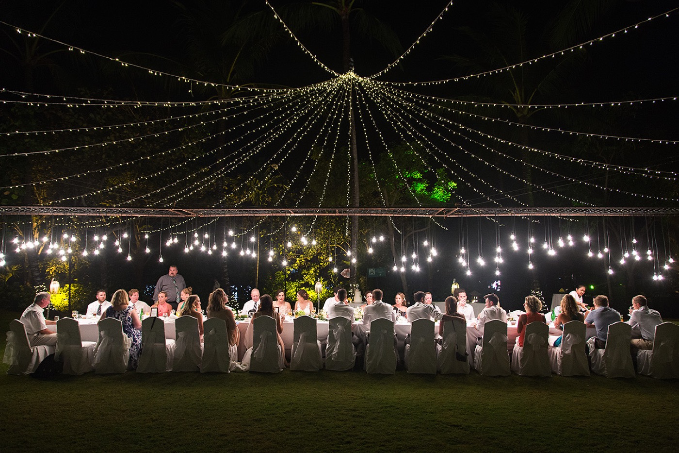Long banquet table under a canopy of fairy lights in the coconut grove at Ayodya Resort Bali, Nusa Dua