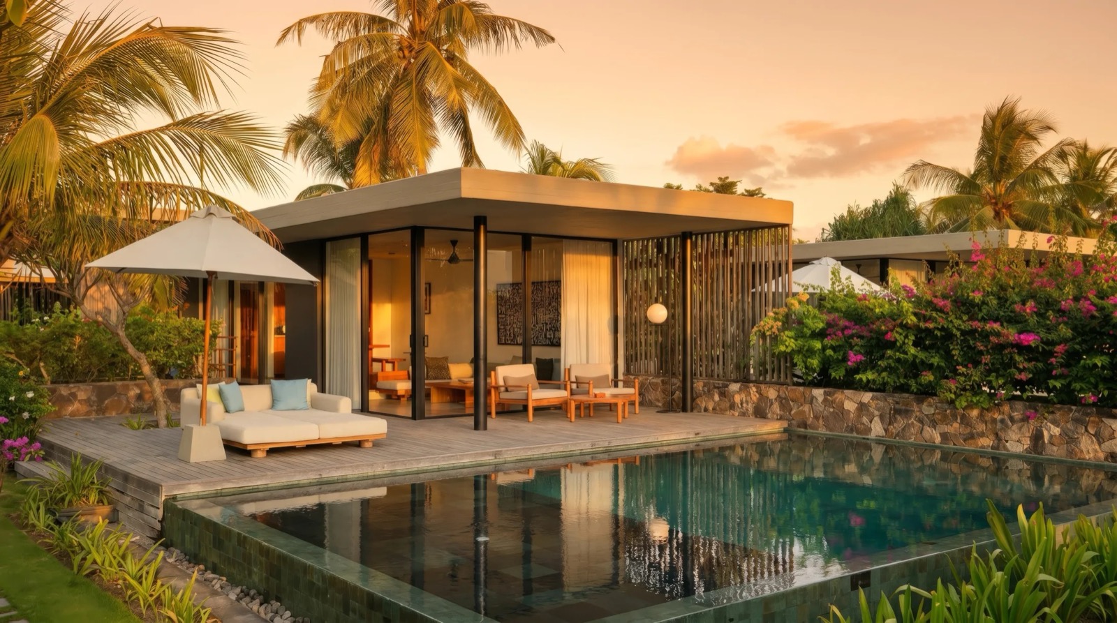 Glass-walled villa with its own plunge pool lit at sunset under the palms at BASK Gili Meno, Gili Meno
