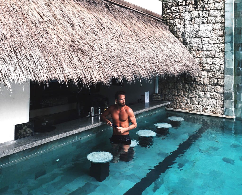 Swim-up pool bar under a thatched roof at Batu Karang Lembongan Resort & Spa on Nusa Lembongan, Bali