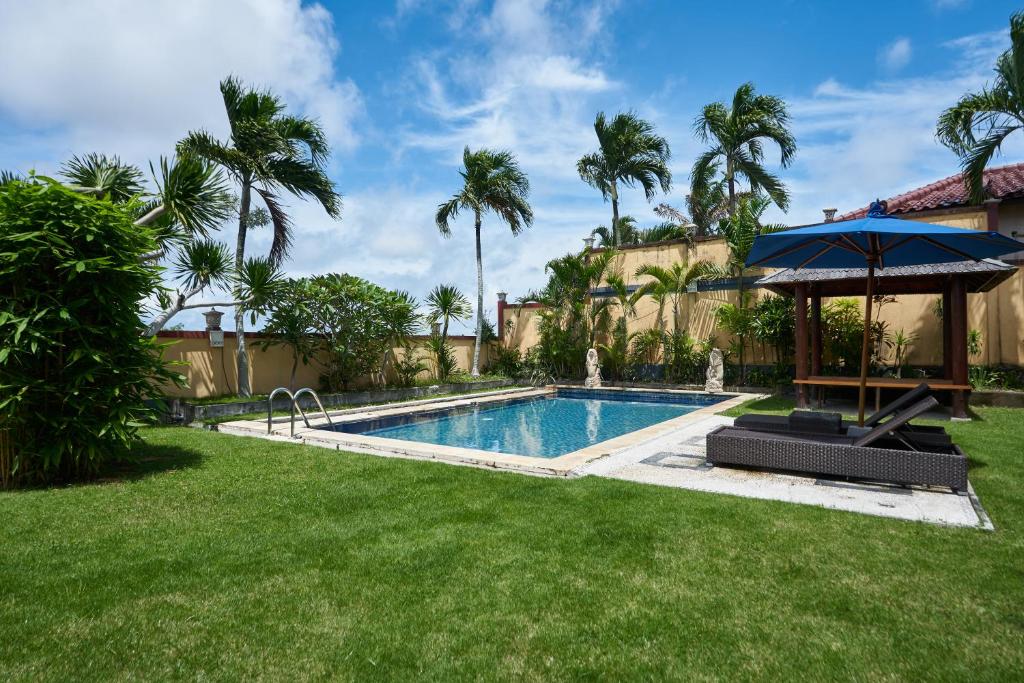 Private pool ringed by palms and a poolside pavilion at The Beverly Hills Bali, Ungasan