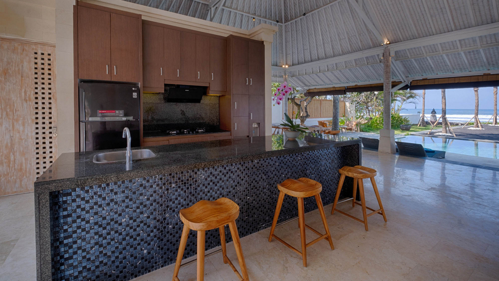 Kitchen and bar area at Biara Villa overlooking the beachfront pool and ocean