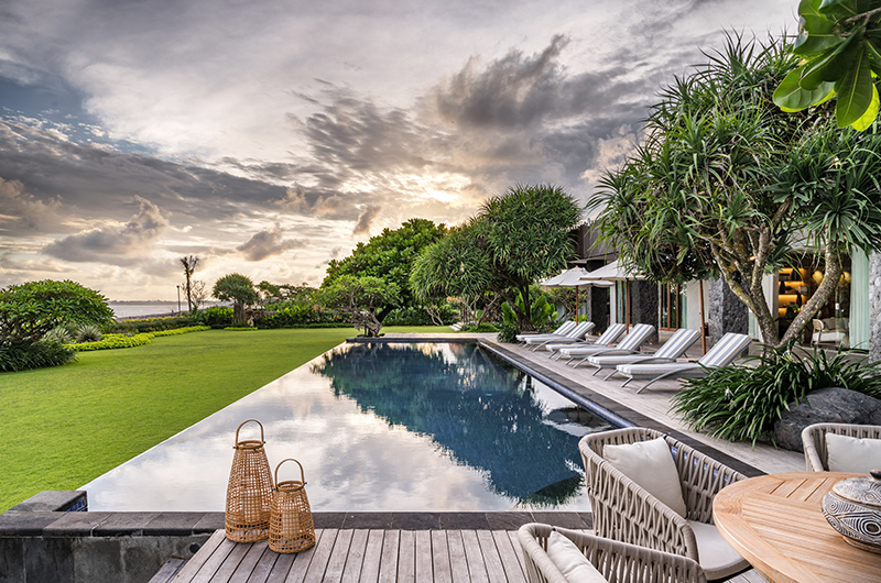 Open living and dining pavilion at Candani Villa looking out to the garden and sea