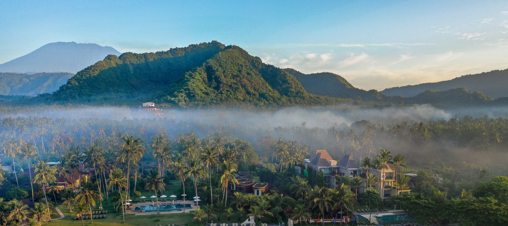 Aerial view of Candi Beach Resort & Spa on Mendira Beach in Candidasa, east Bali, with gardens running down to the white-sand shore