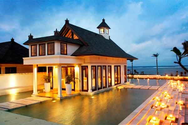 Cloud Nine Chapel lit at dusk beside its reflecting pool with candles, The St. Regis Bali Resort, Nusa Dua