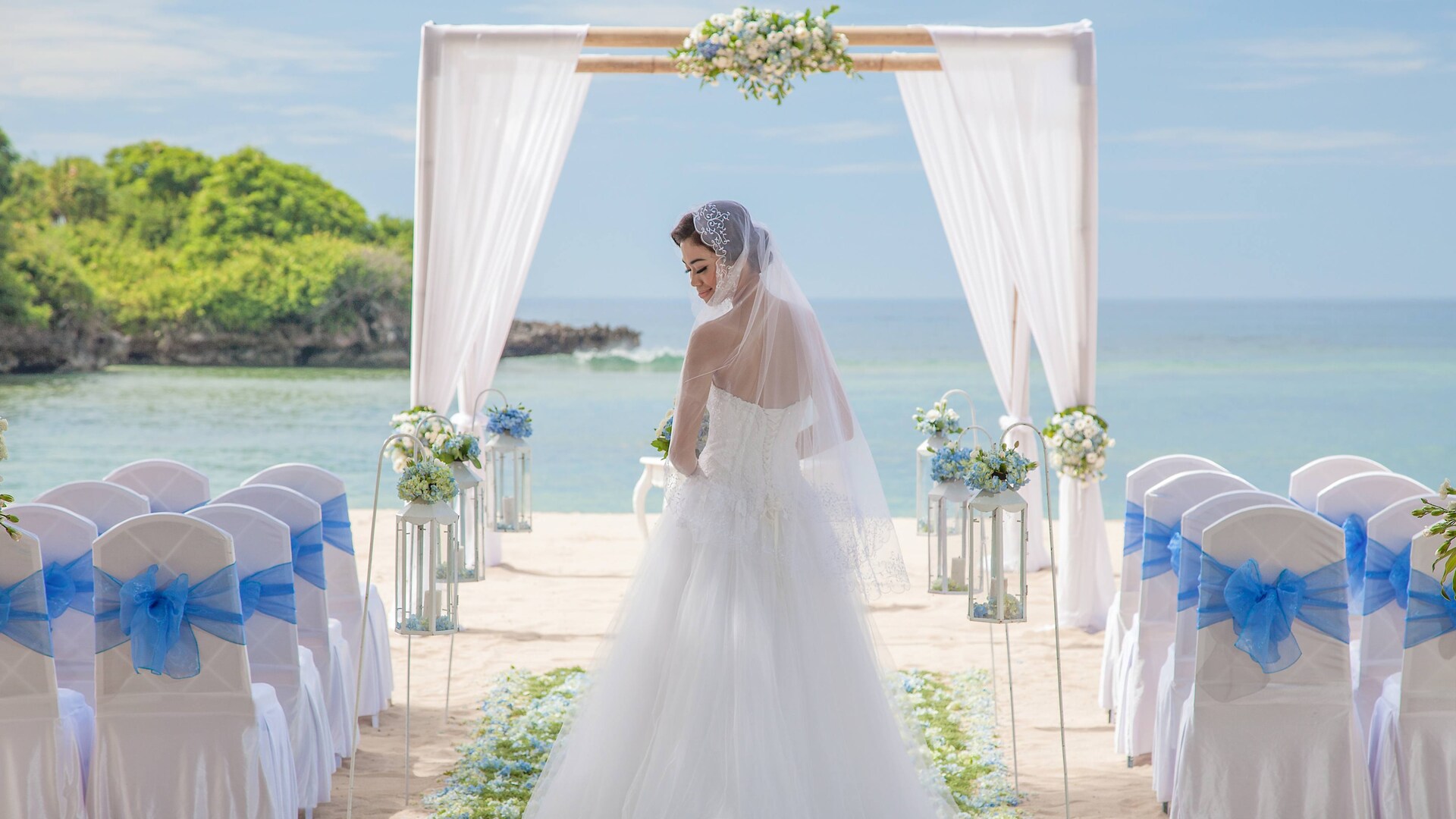 A beach wedding setup on the sand at Courtyard by Marriott Bali Nusa Dua Resort