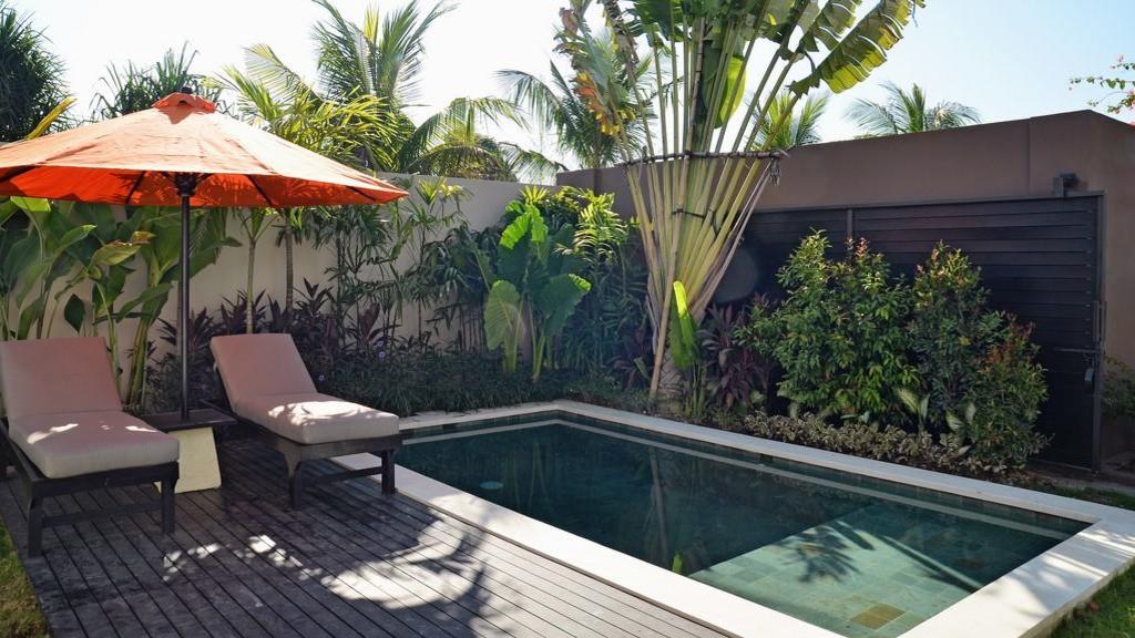 The private plunge pool corner at Echo Beach Duo Villa Enam, framed by tropical planting