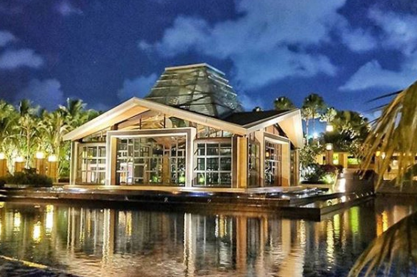 The floating glass Eternity Chapel lit up at night above Mulia Lake, The Mulia, Nusa Dua