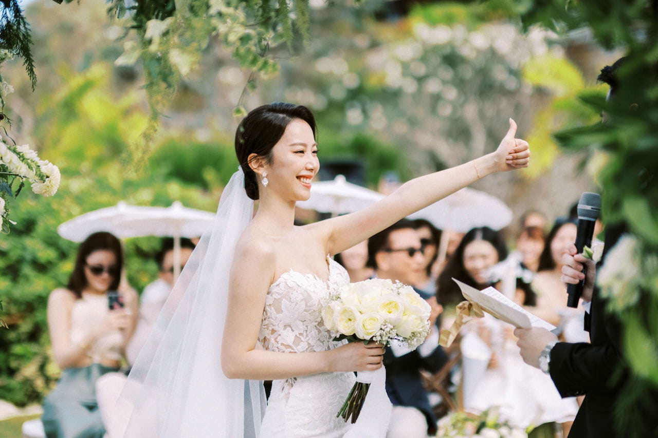 Bride and groom at Four Seasons Jimbaran, with resort grounds backdrop