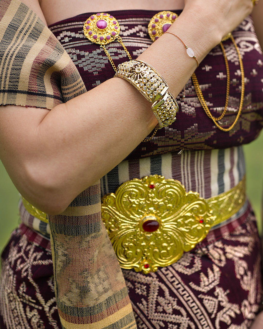 Close view of gold jewellery and songket worn for a Balinese ceremony at Handara Golf & Resort Bali, Pancasari, Bali