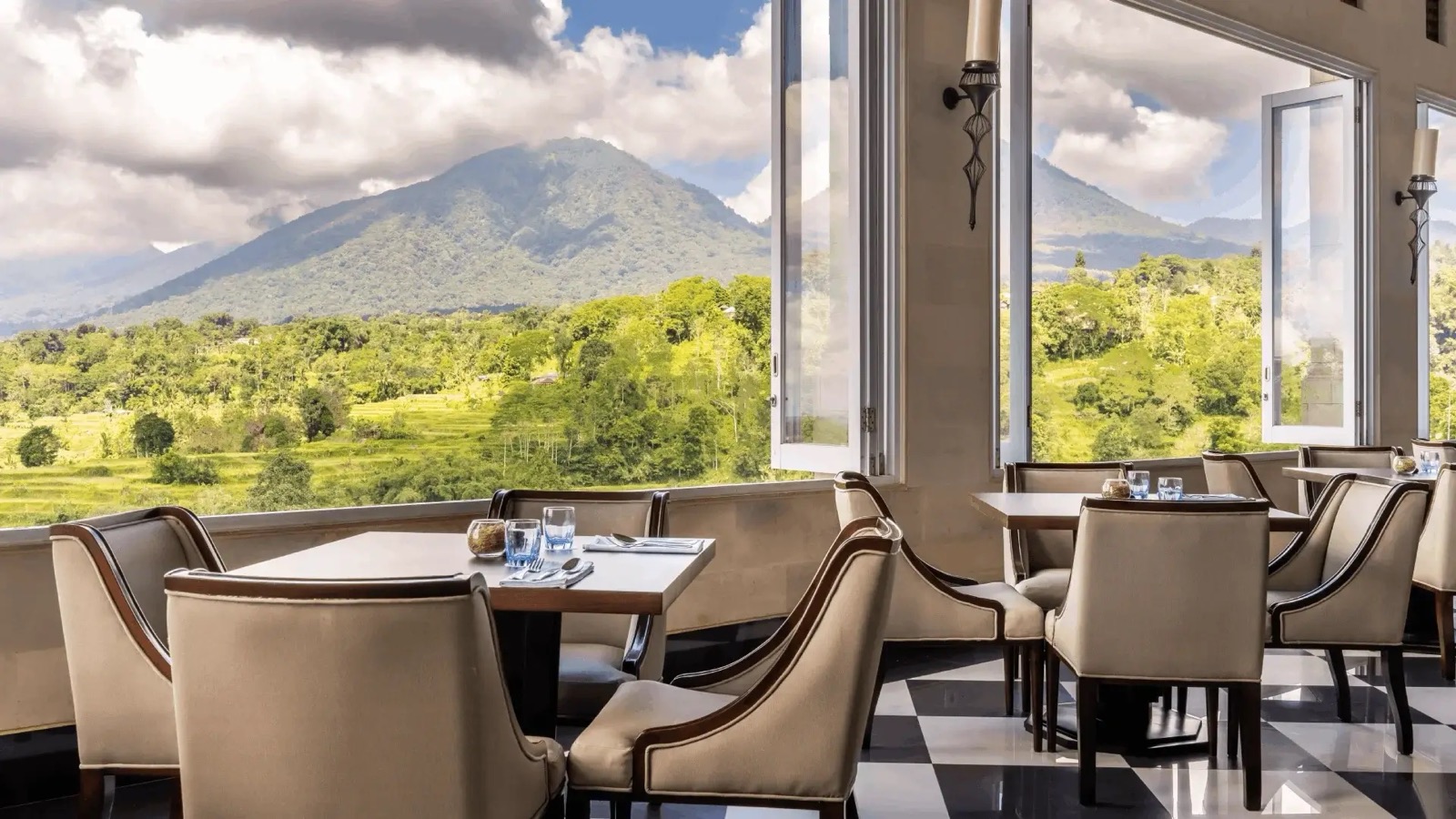 Restaurant with tall white shutters open onto Mount Batukaru and the rice fields at HOMM Saranam Baturiti, Bali
