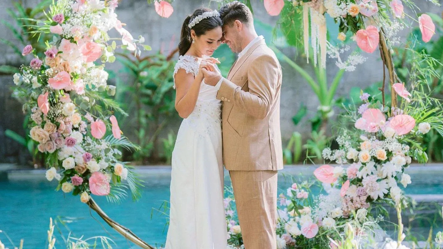 Bride and groom at wedding ceremony with floral decoration at Hotel Indigo Bali Seminyak Beach