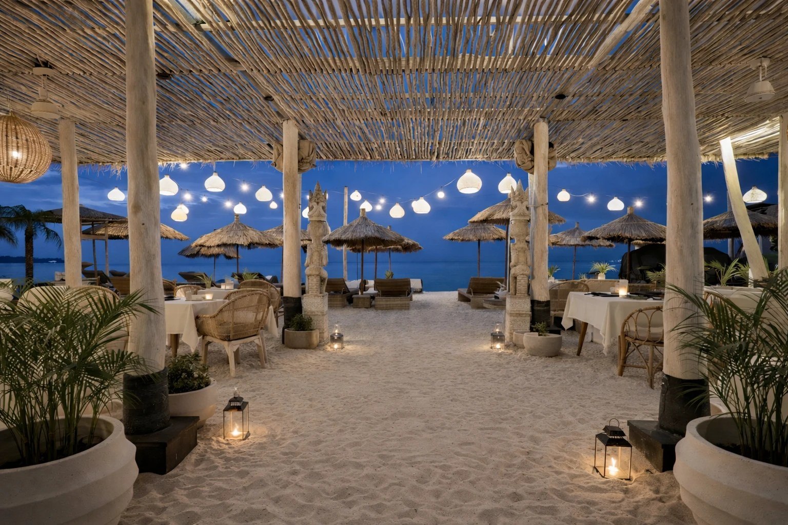 Beach restaurant lit with hanging lanterns at dusk at Indiana Kenanga on Nusa Lembongan, Bali