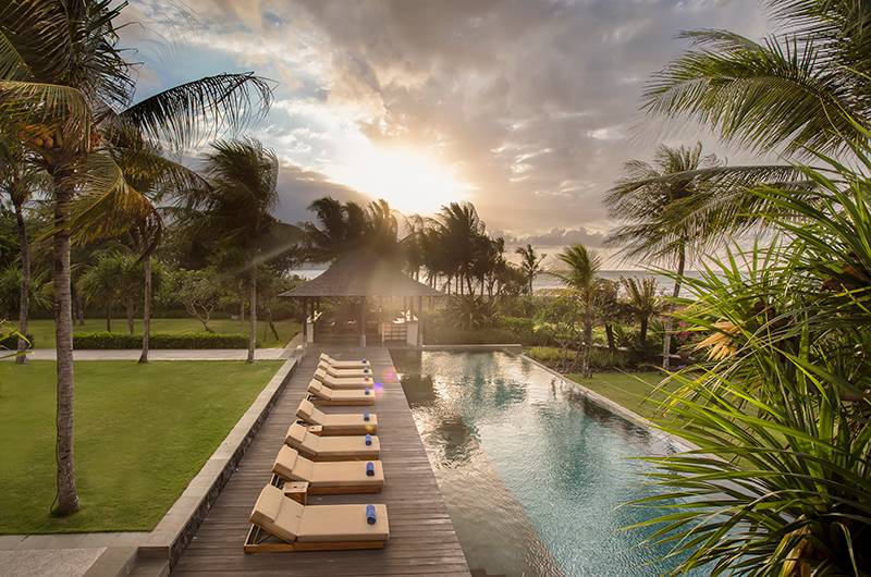 Jeeva Saba's beachfront pool and garden at sunset, sunloungers along the deck and the ocean beyond, Saba Beach, Gianyar