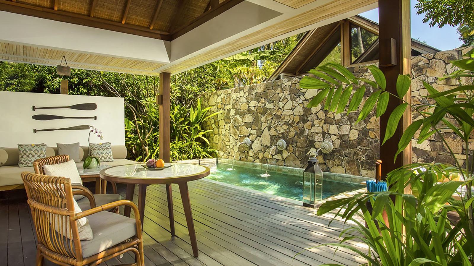 Suite terrace with a plunge pool fed by stone spouts under a thatched roof at Jeeva Santai Villas, Lombok
