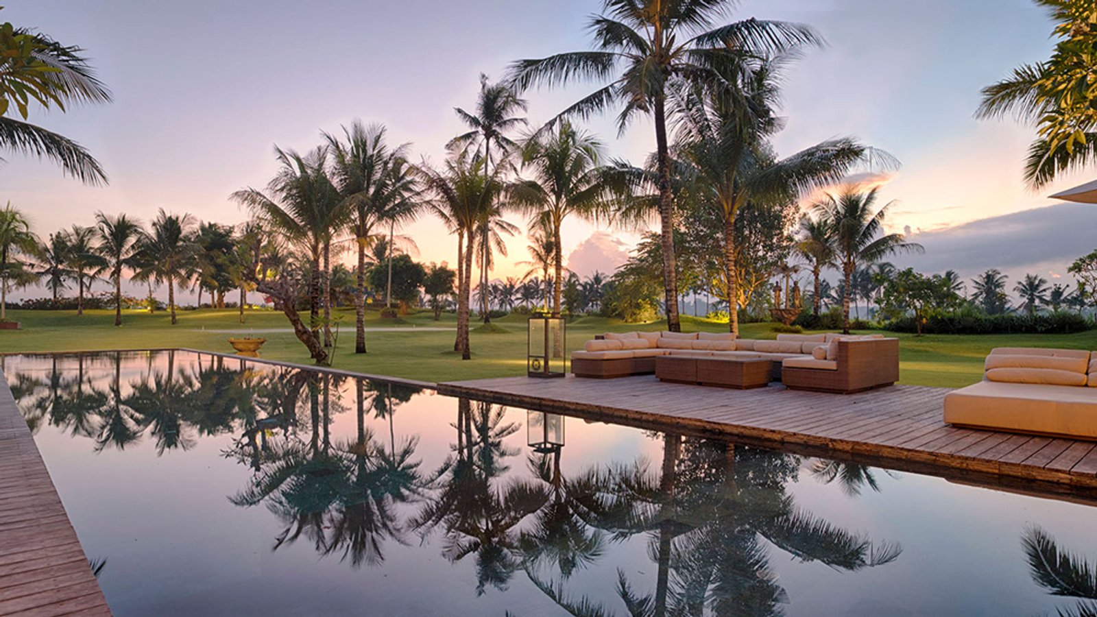 Sunset over the pool deck at Kaba Kaba Estate, framed by rice terraces