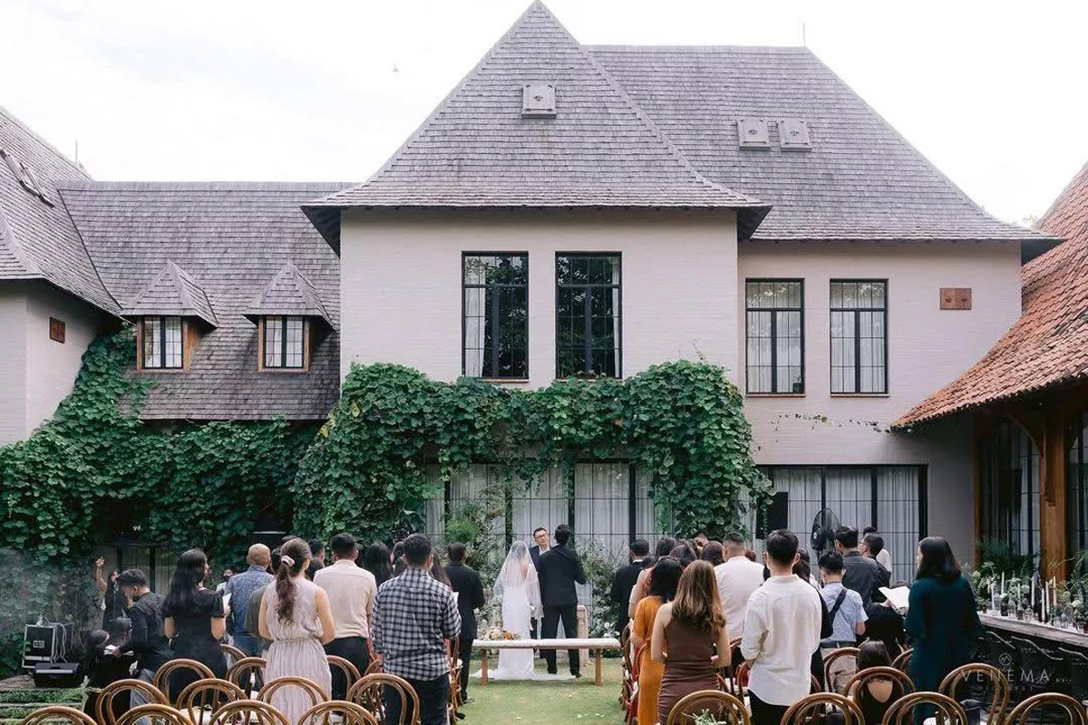 Garden ceremony on the lawn in front of the European-style villa facade at The Kemilau Villa Umalas, Canggu