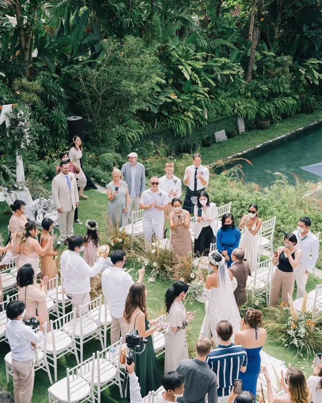 Aerial view of a garden ceremony beside the private pool and tropical greenery at The Kemilau Villa Umalas, Canggu