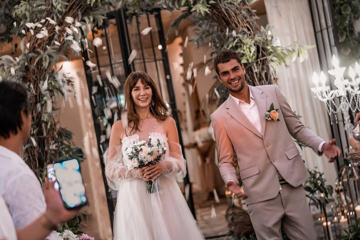 Bride and groom recessional past a chandelier and European-style doorway at The Kemilau Villa Umalas, Canggu