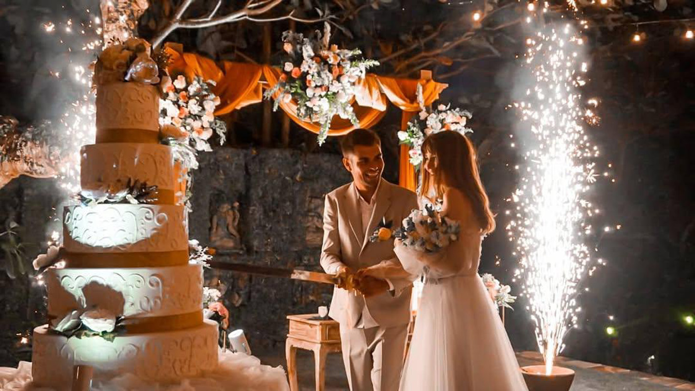 Evening cake cutting with sparklers at a wedding reception at The Kemilau Villa Umalas, Canggu