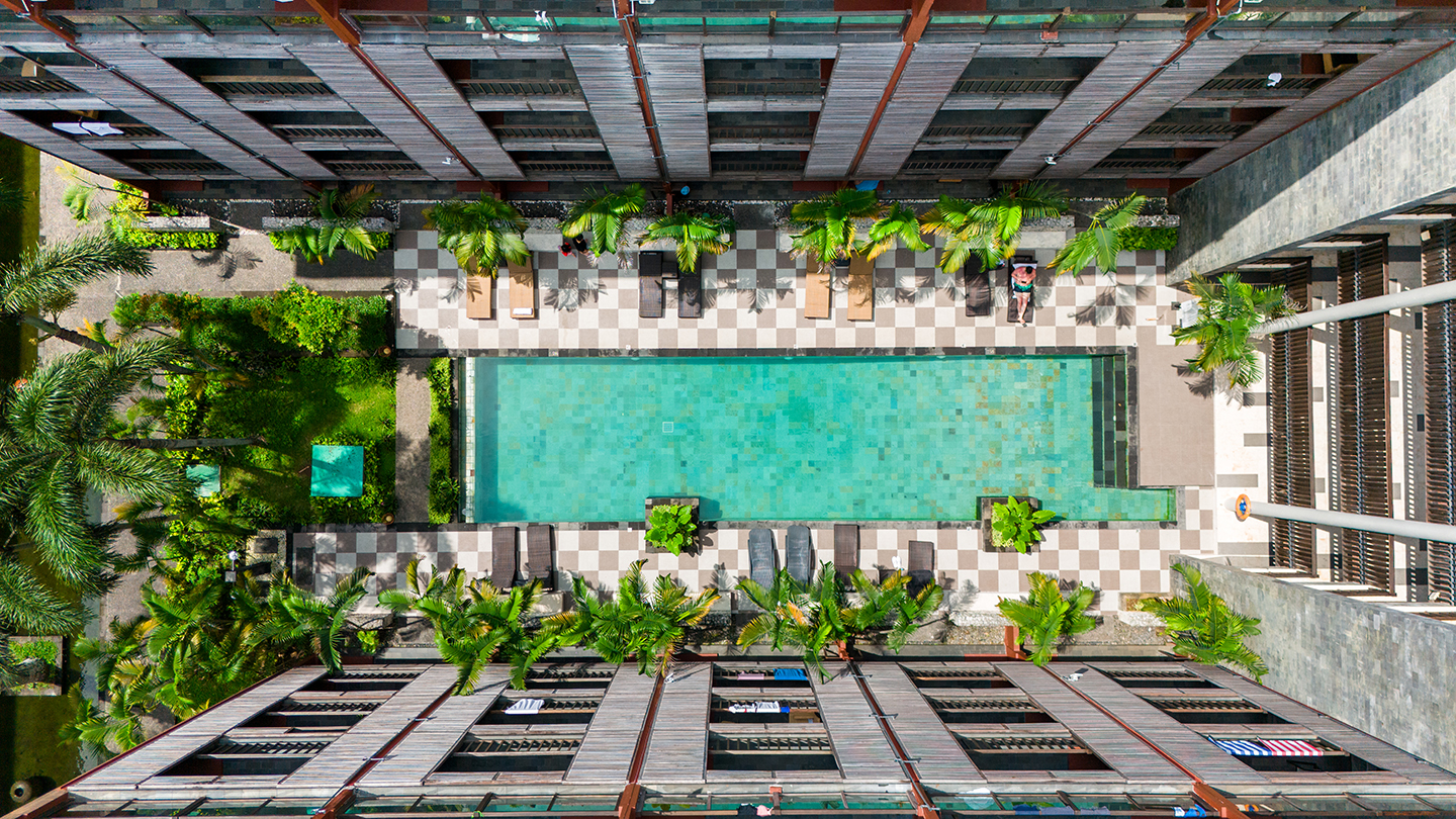 Aerial view of the pool and courtyard at Le Grande Bali Uluwatu with tropical gardens, Pecatu