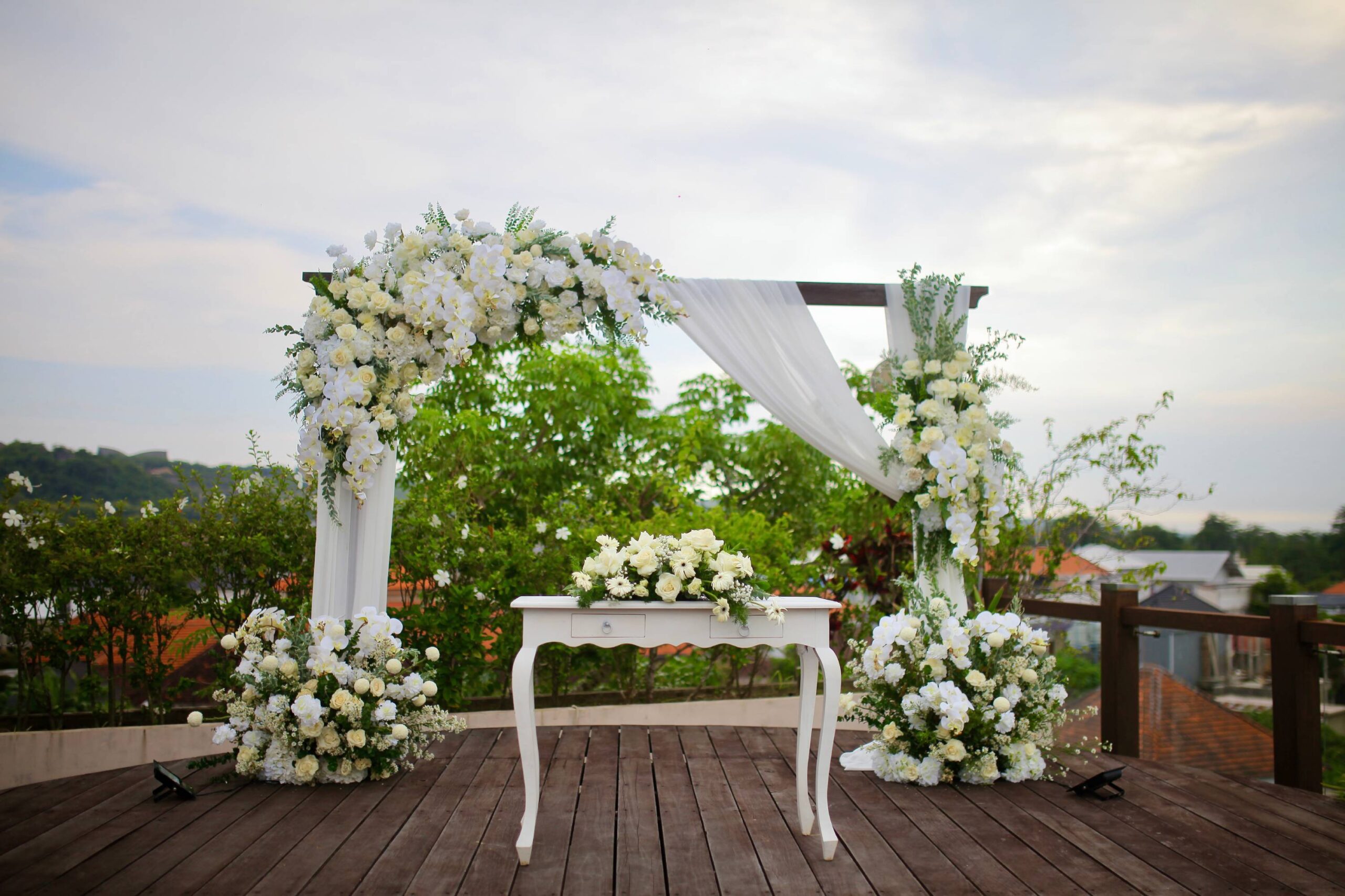 Ceremony detail at The Leaf Jimbaran, with floral styling and seating in the resort grounds
