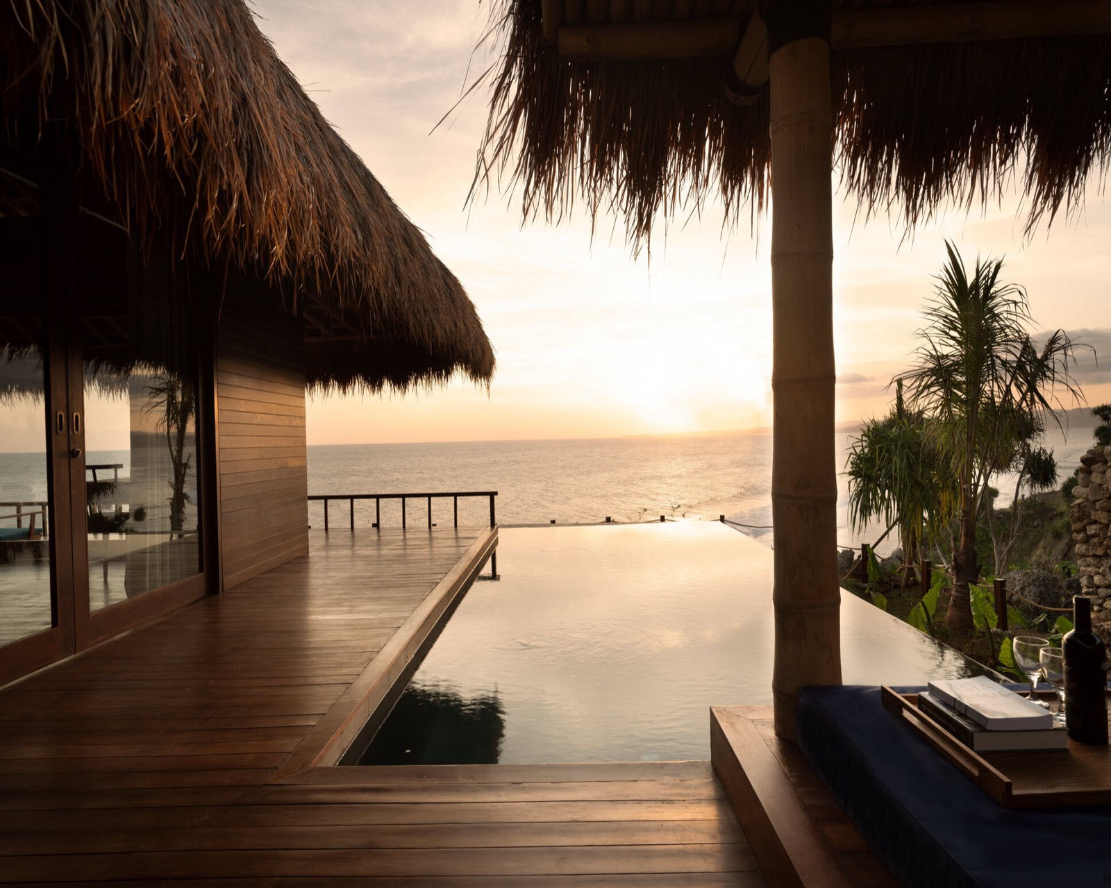 Private villa pool running out toward the ocean at sunset at Lelewatu Resort Sumba, Sumba