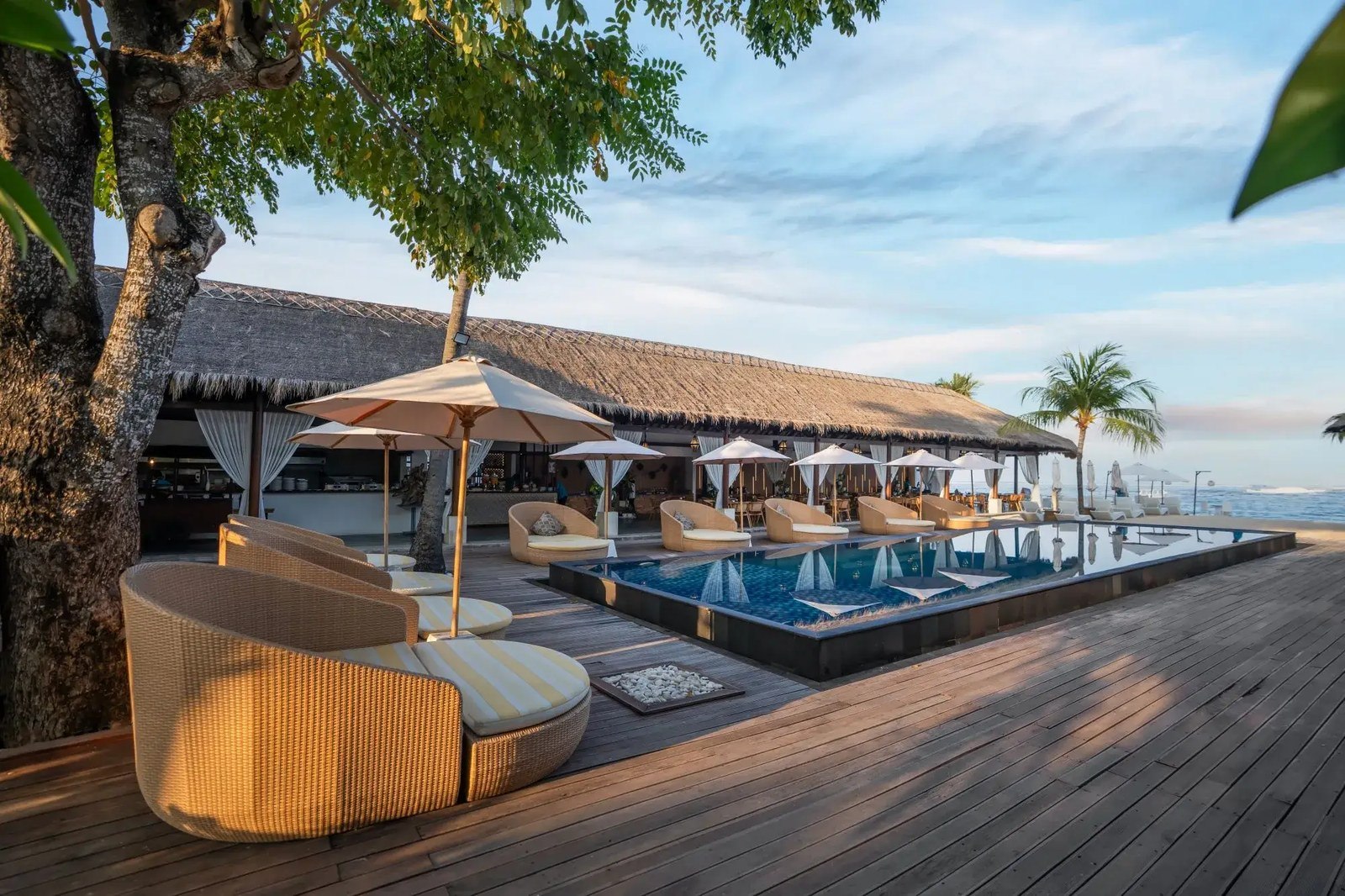 Pool deck and umbrellas on the sand at Lembongan Beach Club & Resort, Jungut Batu, Nusa Lembongan, Bali