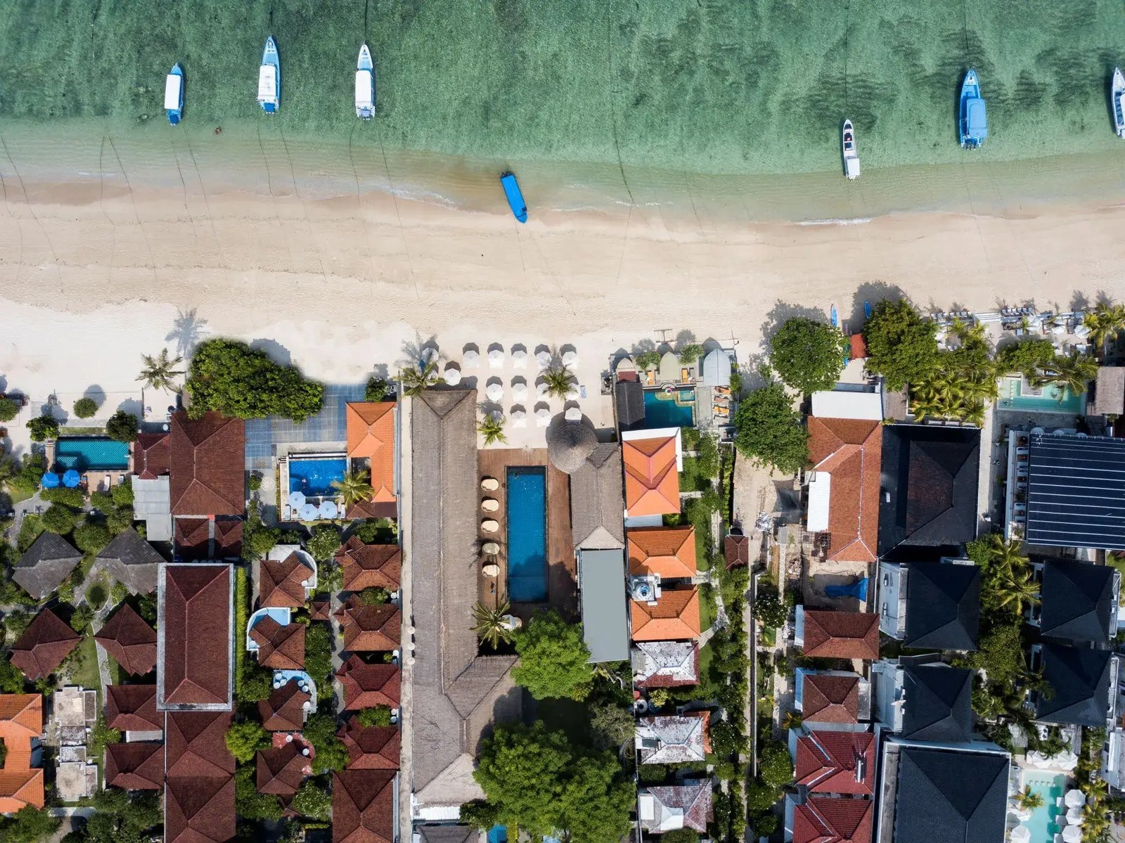 Aerial view of Jungut Batu beach with loungers and jukung boats in front of Lembongan Beach Club & Resort, Nusa Lembongan, Bali