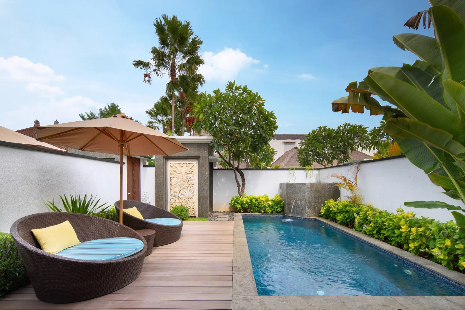 Villa pool with a daybed and palms at Lembongan Beach Club & Resort on Nusa Lembongan, Bali