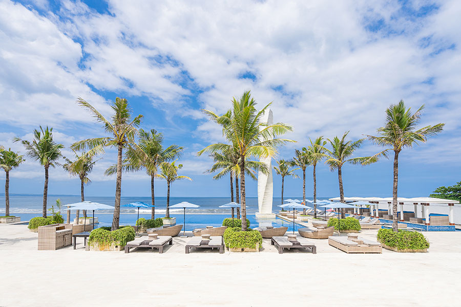 Beach club area with loungers and ocean views at Lv8 Resort Hotel beachfront, Canggu