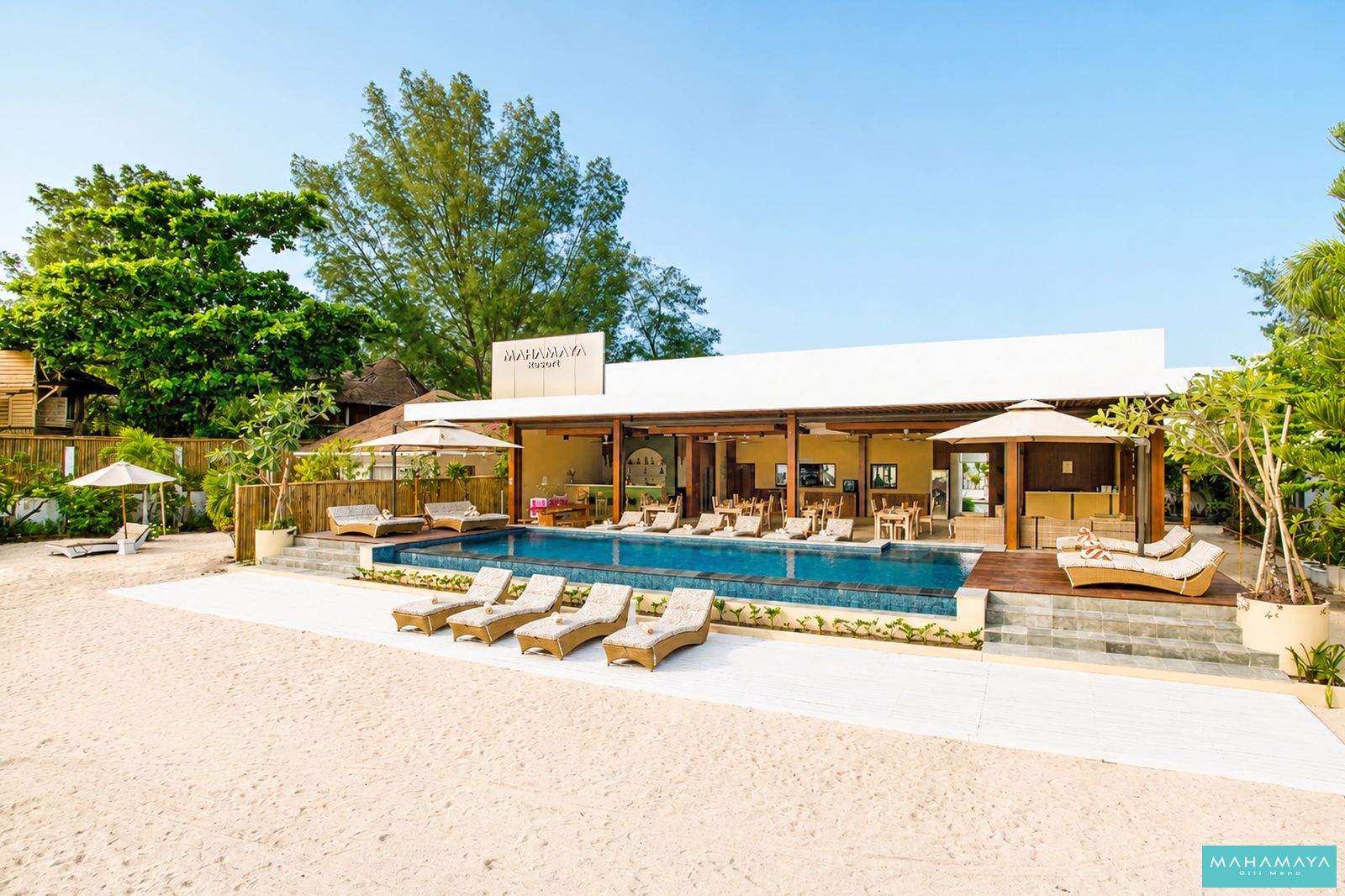 Open-sided restaurant and pool seen from the white sand at Mahamaya Gili Meno, Gili Meno
