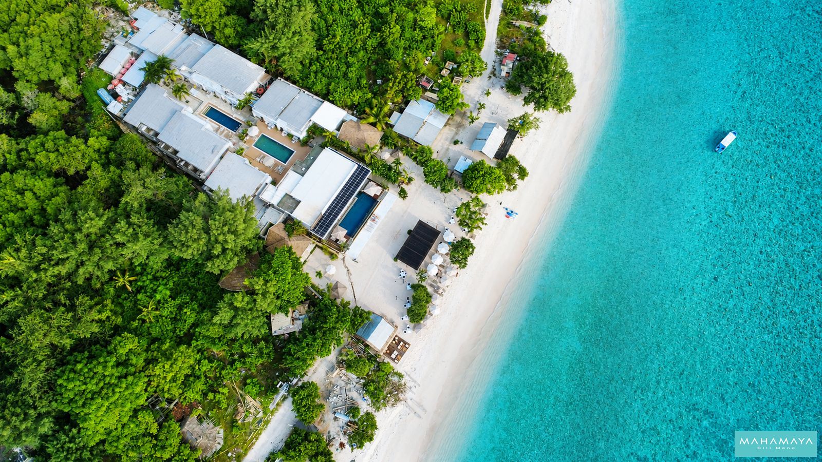 Overhead view of Mahamaya Gili Meno between the trees and the reef on the west coast of Gili Meno