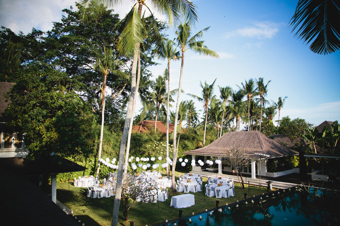 Wedding reception set up on the villa lawn at Mahatma House, with lanterns strung between palm trees